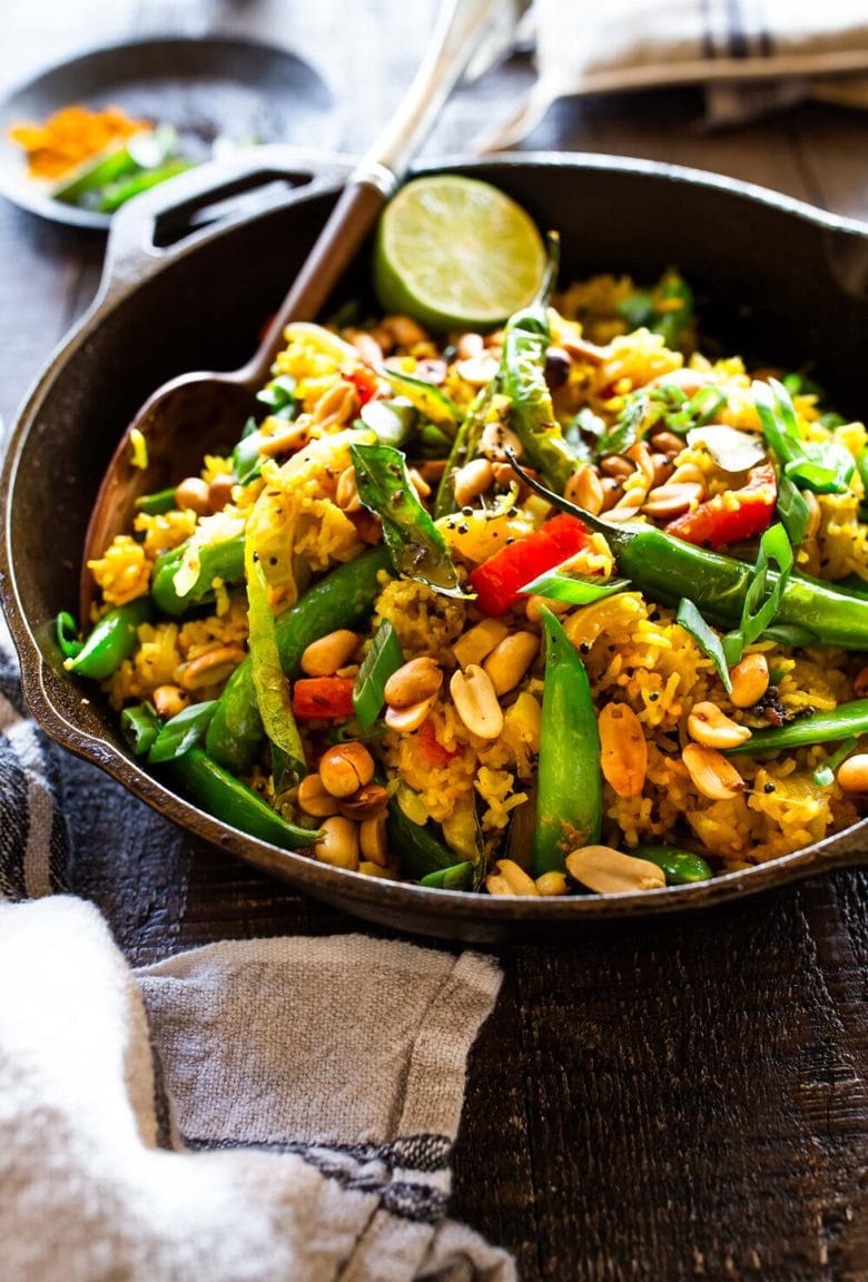 This fragrant, turmeric infused, Indian Fried Rice is full of healthy veggies and can be made in under 30 minutes. Vegetarian, Gluten-free and Vegan adaptable, it is a fast and easy weeknight meal- great for using up leftover rice and veggies in the fridge.