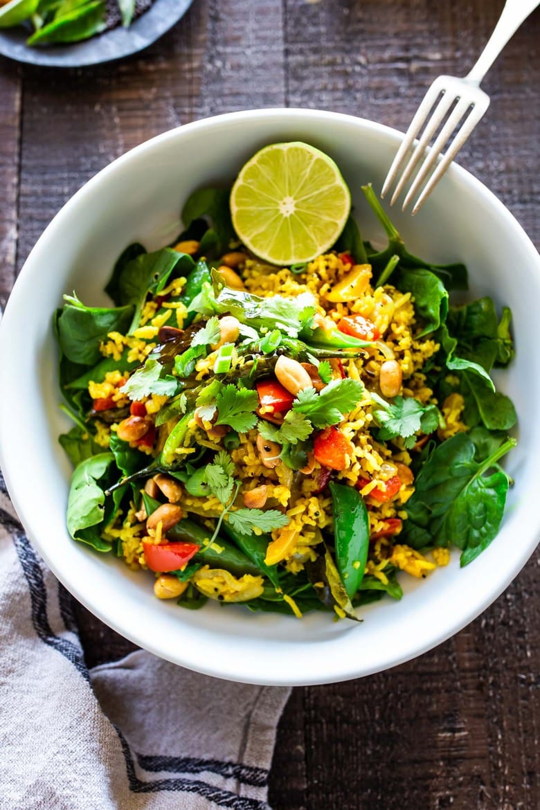 This fragrant, turmeric-infused, Indian Fried Rice is full of healthy veggies and can be made in under 30 minutes. Vegetarian, Gluten-free and Vegan adaptable, it is a fast and easy weeknight meal- great for using up leftover rice and veggies in the fridge.  #turmericrice #veggierice #friedrice #vegandinner 