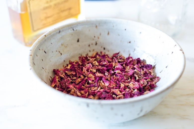 A simple Rose Tincture that opens the heart, quiets the mind and soothes the soul. Calming and uplifting it aids in our overall wellbeing, balancing all 3 doshas. Made with simple ingredients, this takes only 15 minutes of hands-on time! Add a splash of this Wild Rose Elixer to sparkling water, champagne, tea, or cocktails. #tincture #rose #elixir #lovepotion 