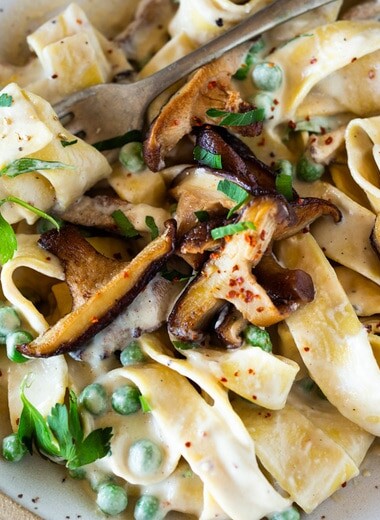 Vegan Alfredo for two, tossed in a delicious cashew (or hemp) cream, with sauteed mushrooms, Meyer lemon zest and a secret ingredient that gives this extra complexity, flavor and depth. Can be made in under 30 minutes! #veganalfredo #veganalfredosauce