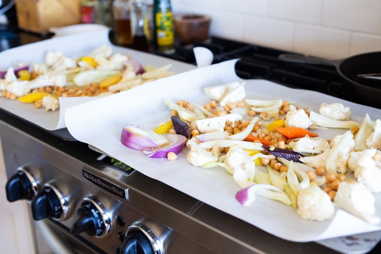 Warm Winter Salad - a hearty, Middle Eastern salad made on a sheet pan with roasted cauliflower, carrots, fennel and chickpeas, topped with wilting spinach, drizzled with Everyday Tahini Sauce and sprinkled with fresh dill and Dukkah. Vegan and Gluten-free. #sheetpandinner #warmsalad #vegansalad #sheetpanmeal #wintersalad #spinachsalad #cauliflowersalad #wintersalad #warmsalad 