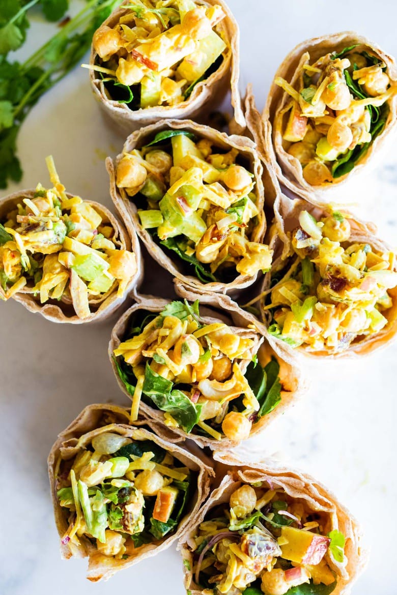 A simple vegan recipe for Curry Chickpea Salad, that can be turned into a wrap with spinach and sprouts. A healthy vegan lunch idea! #veganwrap #currychickpeawrap 