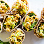 Vegan Curry Chickpea Salad Wrap with cashews, coconut, dates and celery.