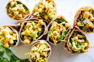 Vegan Curry Chickpea Salad Wrap with cashews, coconut, dates and celery.