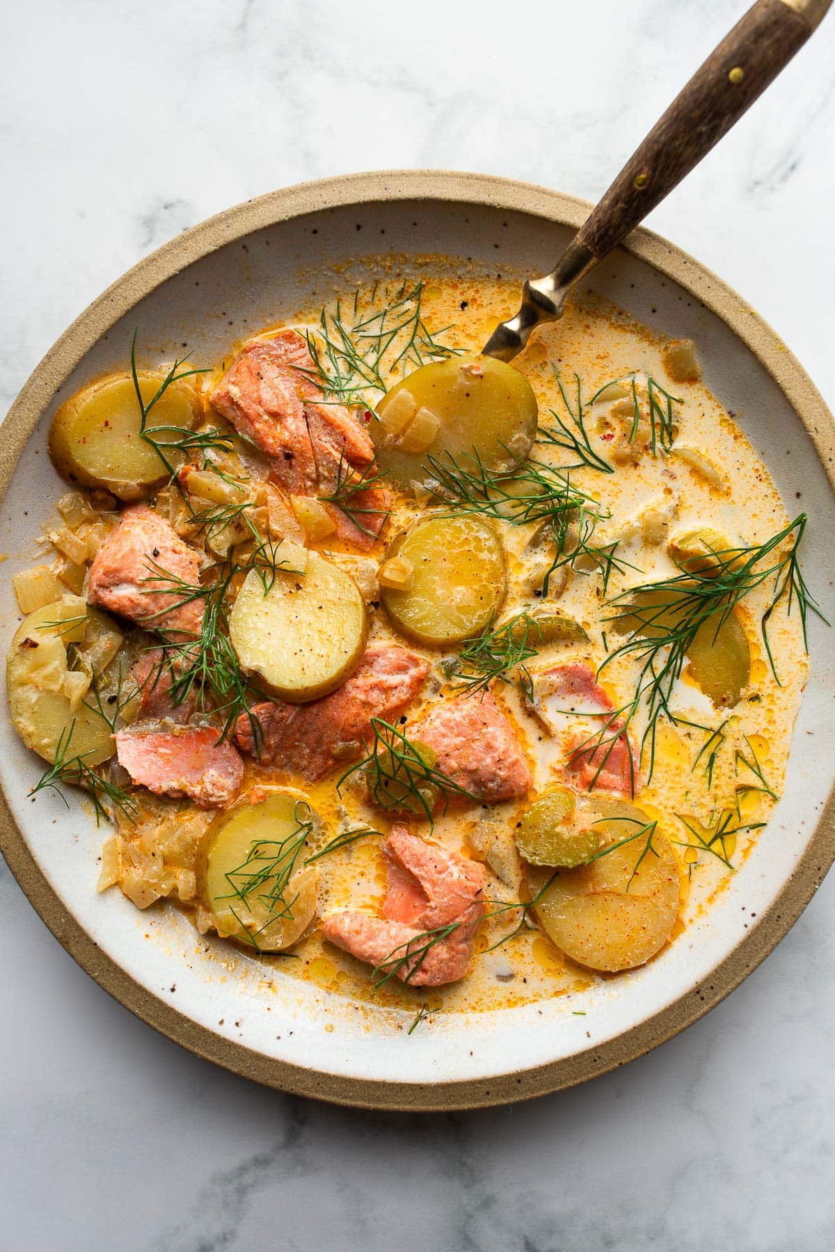 Salmon chowder with dill in a bowl.