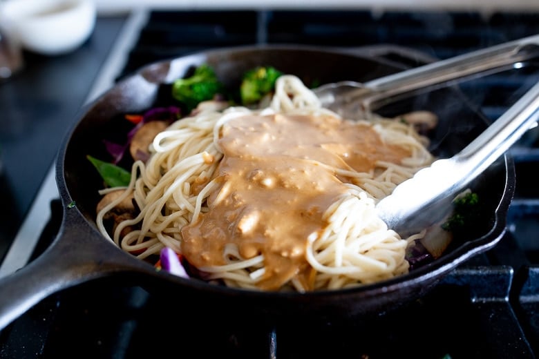 Creamy, vegan Sesame Noodles, loaded up with healthy veggies and tossed in the most delicious Sesame Sauce made with tahini paste! Make this in 20 minutes flat and keep it vegan or add chicken- up to you! #sesamenoodles #vegan #noodlebowl