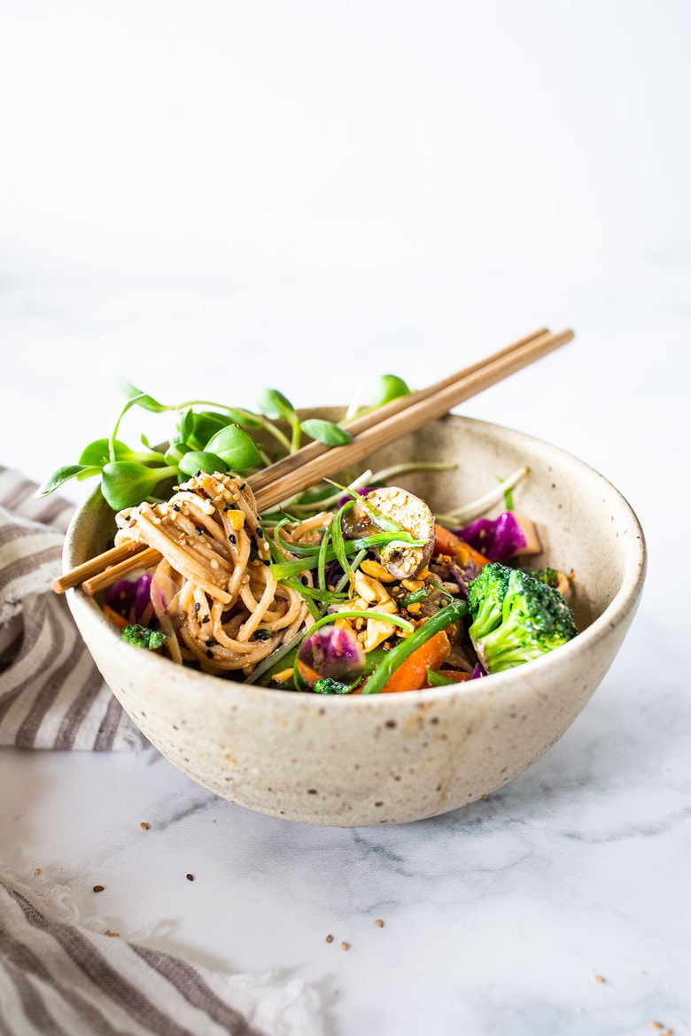 Flavorful Sesame Noodles, loaded up with healthy veggies and tossed in the most delicious, creamy, vegan Sesame Sauce! Make this in 20 minutes flat! Keep it vegan or add chicken- up to you! #sesamenoodles #vegan #noodlebowl
