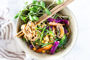 Flavorful Sesame Noodles, loaded up with healthy veggies and tossed in the most delicious, creamy, vegan Sesame Sauce! Make this in 20 minutes flat! Keep it vegan or add chicken- up to you! #sesamenoodles #vegan #noodlebowl