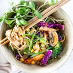 Flavorful Sesame Noodles, loaded up with healthy veggies and tossed in the most delicious, creamy, vegan Sesame Sauce! Make this in 20 minutes flat! Keep it vegan or add chicken- up to you! #sesamenoodles #vegan #noodlebowl