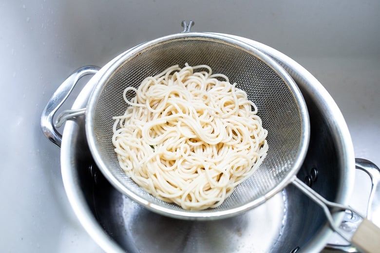 Flavorful Sesame Noodles, loaded up with healthy veggies and tossed in the most delicious, creamy, vegan Sesame Sauce! Make this in 20 minutes flat! Keep it vegan or add chicken- up to you! #sesamenoodles #vegan #noodlebowl