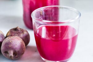 How to Make Beet Kvass! A sparkly Ukrainian probiotic drink made with beets, sea salt and water. Full of healthy probiotics from the Lacto-fermentation, Beet Kvass is believed to help boost immunity.  It tastes slightly sweet, tangy, earthy and salty- but in a good way! With just 10 minutes of hands-on time,it is so simple- just let mother nature take its course.  (Allow 2 weeks for fermentation- see notes for speeding up this process.)