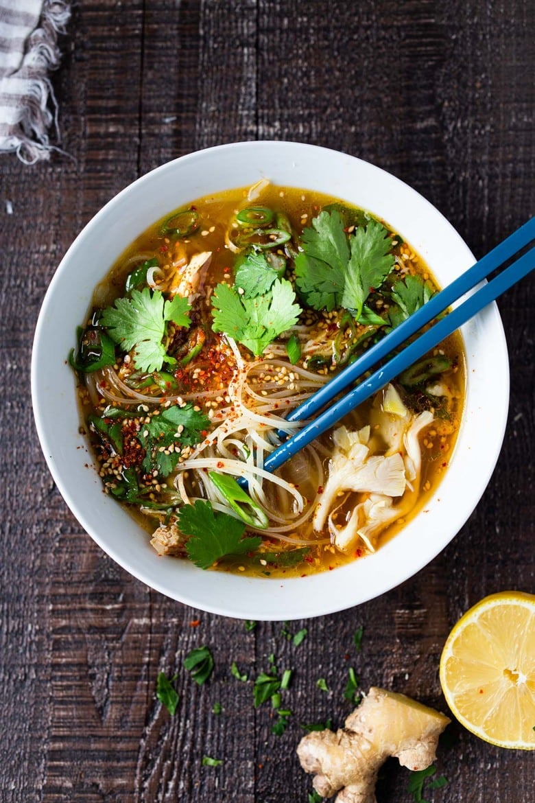 Feel Better Chicken Soup with Lemon and Ginger will warm you to your bones! Brothy and flavorful, this highly-adaptable recipe is the perfect base for your own creations- use whatever grain or starch you prefer- noodles, rice quinoa, beans- or keep it keto and low-carb! Can also be made in an Instant Pot or Slow cooker! #chickensoup #ketosoup #broth