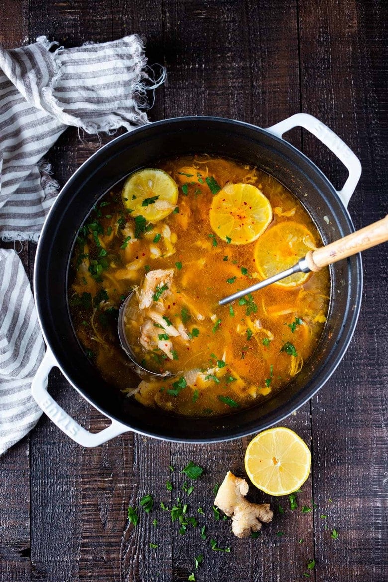 Feel Better Chicken Soup with Lemon and Ginger will warm you to your bones! Brothy and flavorful, this highly-adaptable recipe is the perfect base for your own creations- use whatever grain or starch you prefer- noodles, rice quinoa, beans- or keep it keto and low-carb! Can also be made in an Instant Pot or Slow cooker! #chickensoup #ketosoup #broth