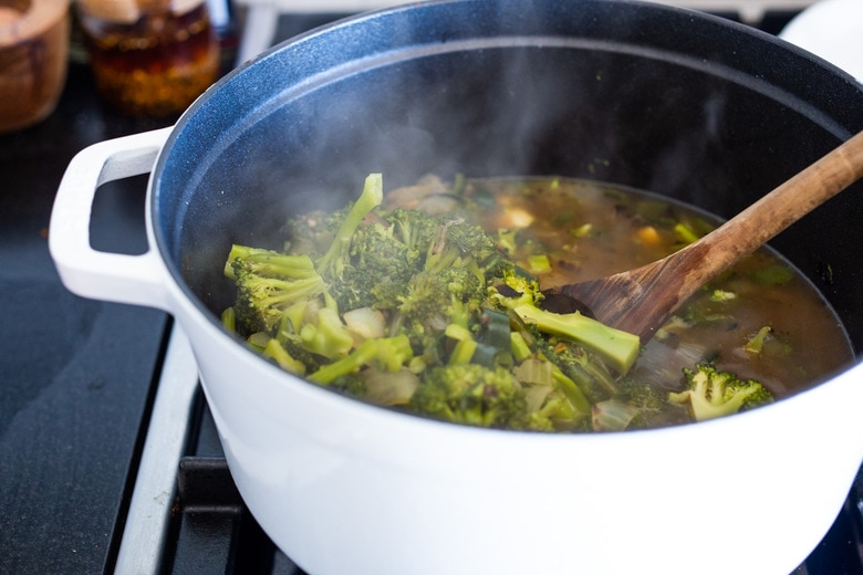 Add broth, salt and pepper, reduce heat and simmer.