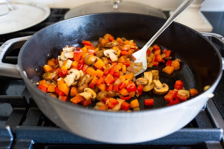 chopped veggies sautéing in skillet.