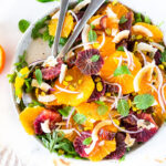 Citrus Salad with dates, arugula, mint, pistachios, and toasted coconut is dressed in the most flavorful Citrus Shallot Vinaigrette. It's deliciously juicy and vegan! #citrussalad #orangesalad