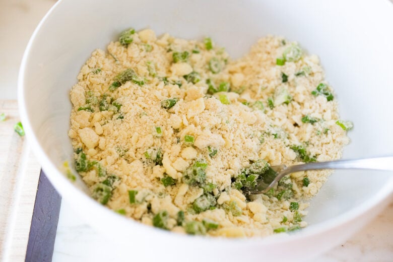 Adding scallions sourdough biscuit dough.