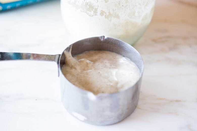 Adding starter to sourdough biscuits.