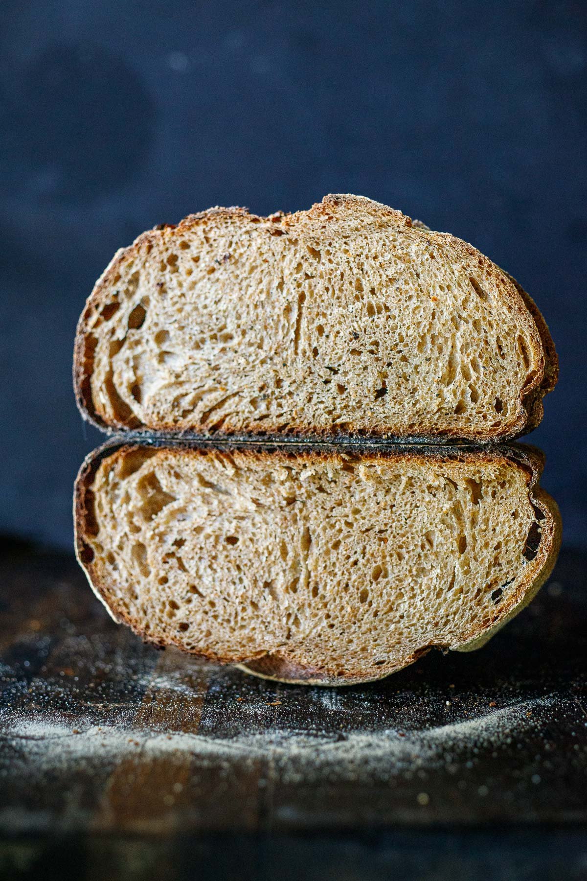 A loaf ouf sourdough cut in half to show the inside of the bread.