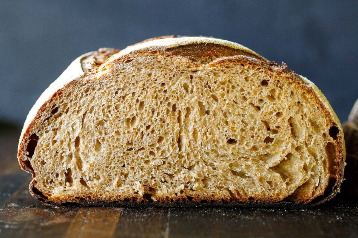 A sourdough loaf sliced in half.
