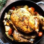 How to roast A Whole Chicken with Lemon, Garlic and Rosemary baked in the oven over vegetables, all in ONE pan! Simple & Delicious! #wholeroastedchicken #roastchicken #roastedchicken