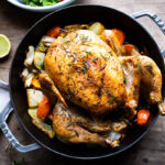 How to roast a WHOLE CHICKEN! Easy Roast Chicken with lemon, garlic and rosemary, baked in the oven over vegetables. A delicious dinner recipe! #roastchicken