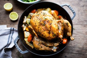 How to roast a WHOLE CHICKEN! Easy Roast Chicken with lemon, garlic and rosemary, baked in the oven over vegetables. A delicious dinner recipe! #roastchicken