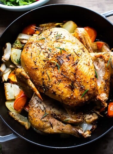 How to roast a WHOLE CHICKEN! Easy Roast Chicken with lemon, garlic and rosemary, baked in the oven over vegetables. A delicious dinner recipe! #roastchicken