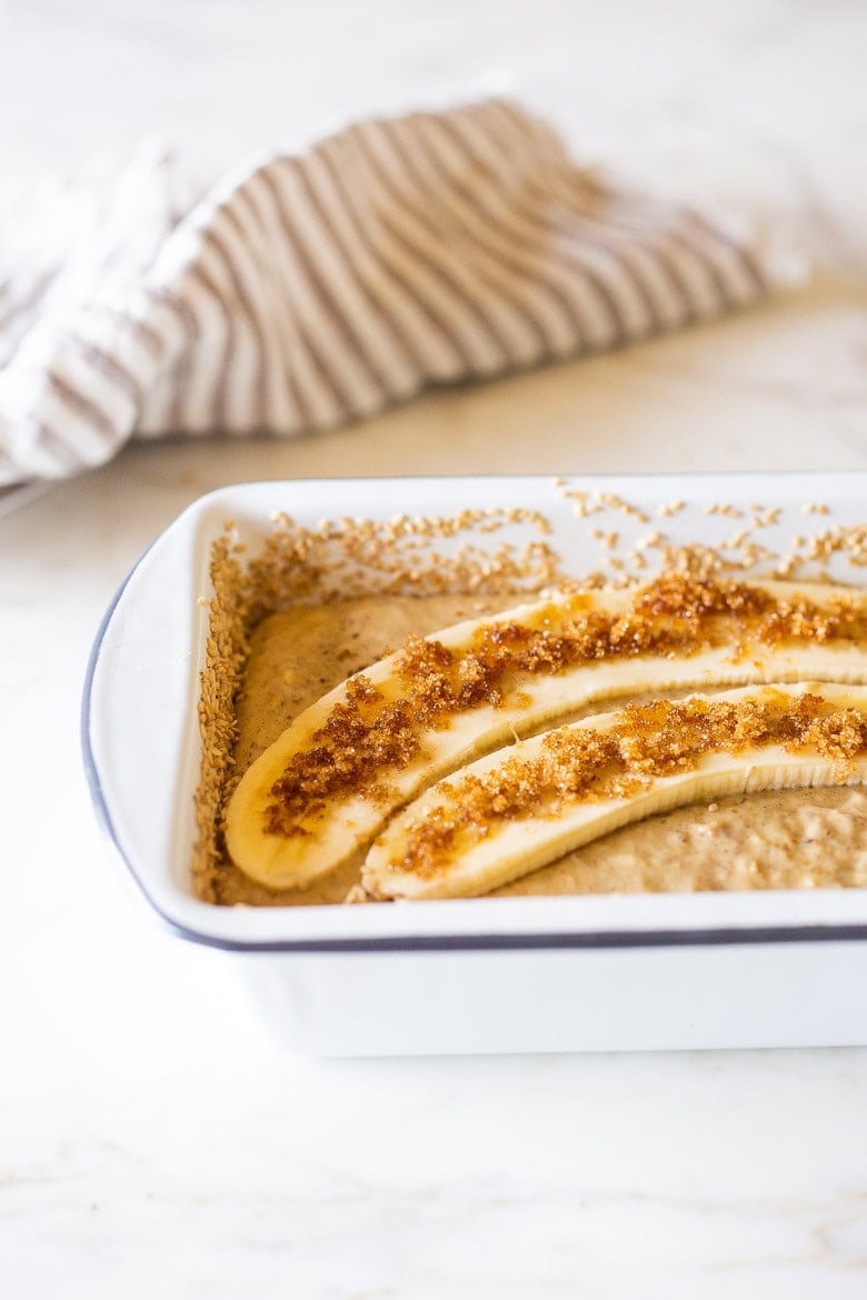 This Banana bread is not only healthy and vegan, but it can also be made with sourdough starter or discard! Infused with ginger, spices and crusted with sesame seeds it is flavorful and moist. #bananabread #veganbananabread #sourdough #yeastless