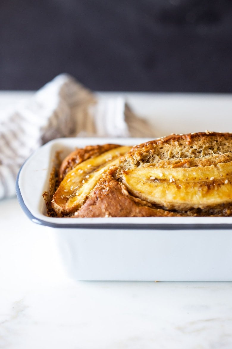 This Banana bread is not only healthy and vegan, but it can also be made with sourdough starter or discard! Infused with ginger, spices and crusted with sesame seeds it is flavorful and moist. #bananabread #veganbananabread #sourdough #yeastless 