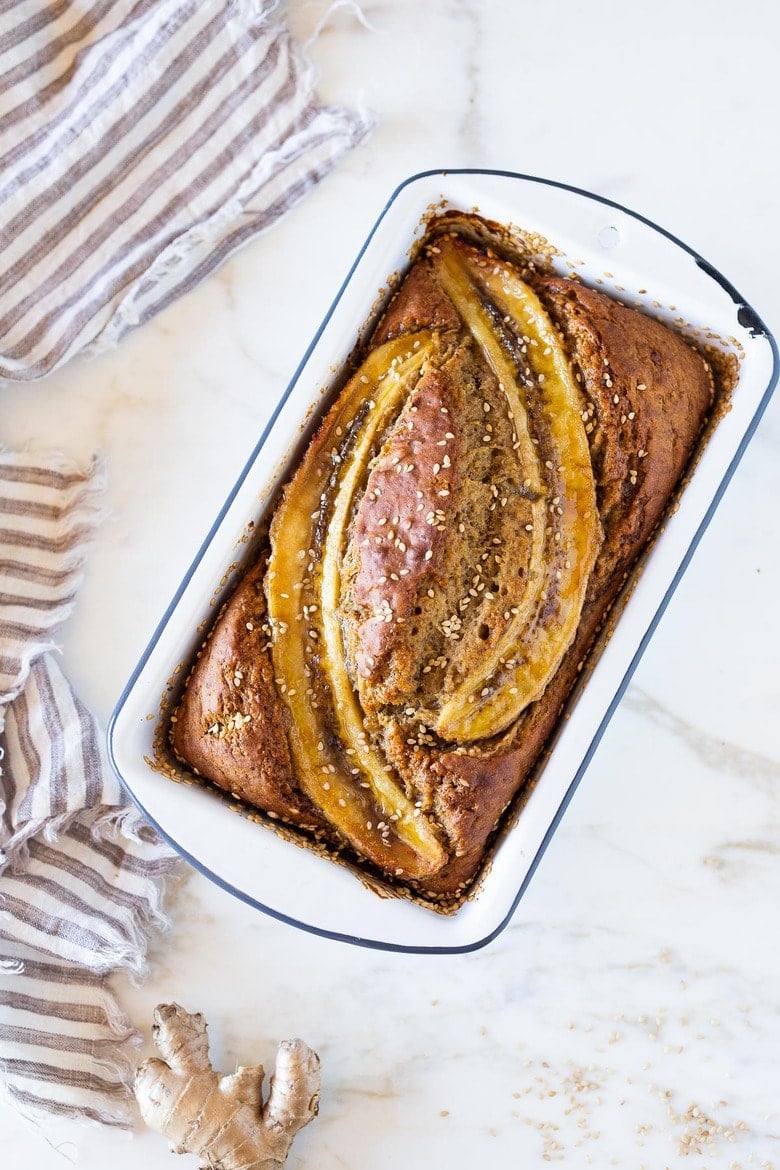 This Banana bread is not only healthy and vegan, but it can also be made with sourdough starter or discard! Infused with ginger, spices and crusted with sesame seeds it is flavorful and moist. #bananabread #veganbananabread #sourdough #yeastless 