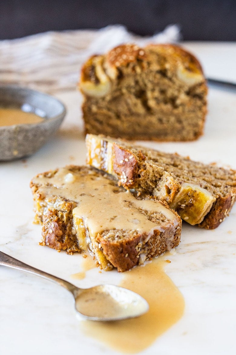 This Banana bread is not only healthy and vegan, but it can also be made with sourdough starter or discard! Infused with ginger, spices and crusted with sesame seeds it is flavorful and moist. #bananabread #veganbananabread #sourdough #yeastless 