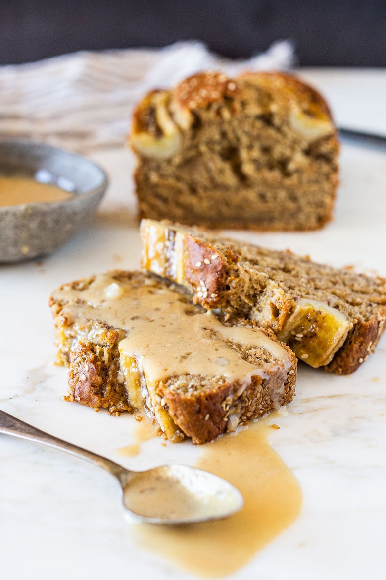 This Banana bread is not only healthy and vegan, but it can also be made with sourdough starter or discard! Infused with ginger, spices and crusted with sesame seeds it is flavorful and moist. #bananabread #veganbananabread #sourdough #yeastless