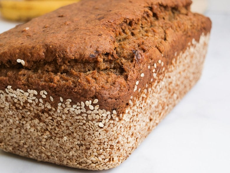 This Vegan Banana bread is not only healthy, it's made with sourdough starter or discard! Infused with ginger and sesame it is full of amazing flavor! #bananabread #veganbananabread #sourdough #yeastless