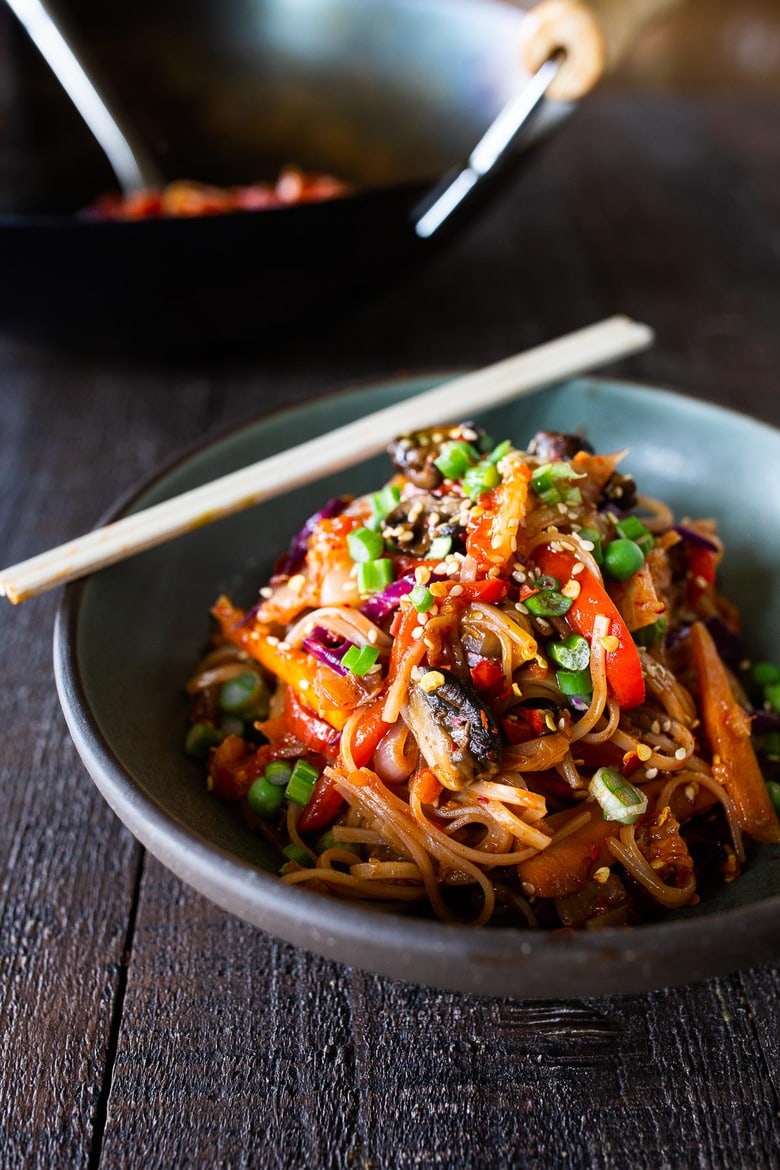 A flavorful recipe for Kimchi Noodles stir-fried with healthy veggies. Keep it vegan or add an egg, crispy tofu, chicken or shrimp! 