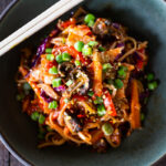 Here's a super tasty recipe for Vegan Kimchi Noodles, stir-fried with lots of healthy veggies you probably have on hand. Keep it vegan or add an egg, chicken or shrimp! Crispy tofu is also a delicious option here! #kimchi #kimchinoodles #kimchirecipes #vegannoodles