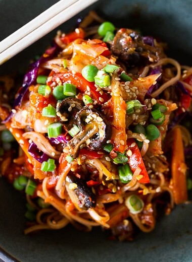 Here's a super tasty recipe for Vegan Kimchi Noodles, stir-fried with lots of healthy veggies you probably have on hand. Keep it vegan or add an egg, chicken or shrimp! Crispy tofu is also a delicious option here! #kimchi #kimchinoodles #kimchirecipes #vegannoodles