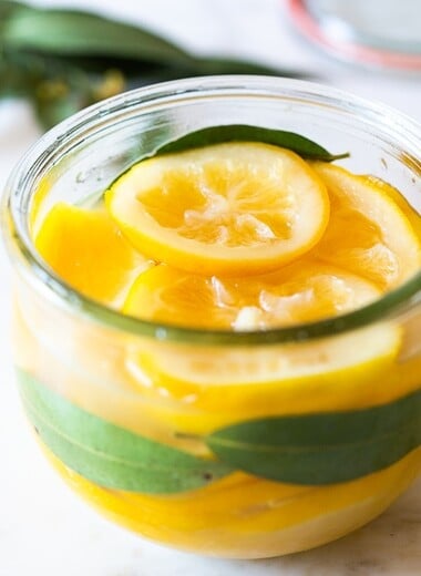 How to Preserve Lemons- a simple easy way to preserve lemons that only takes 10 minutes of hands-on time before letting mother nature take its course. Use in dressings, marinades, Middle Eastern Dishes and salad to add a burst of flavor. #preservedlemons