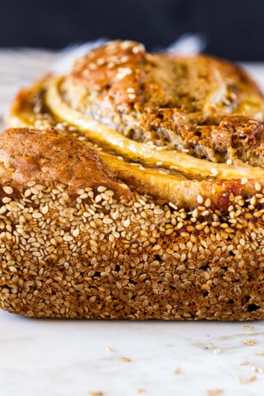 Here's a healthy, delicious recipe for Banana Bread with a toasty Sesame Seed Crust. Infused with ginger, it's moist and flavorful. Vegan-adaptable, and can be made with sourdough starter.