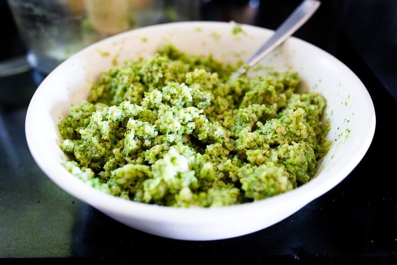 broccoli quinoa cake batter in bowl with spoon.