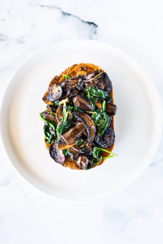A simple healthy vegan recipe for Mushroom Toast with Garlic, Thyme and lemon zest. Serve it as a meal with a haearty salad, or top it with an egg for breakfast. A great way to use up sourdough bread! #mushroomtoast