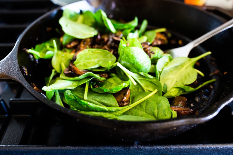 sautéing mushrooms, garlic and spinach for mushroom toast 