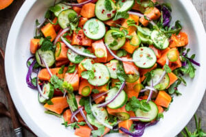 A simple Mexican-inspired Papaya Salad using ripe papaya with cucumber, red onions, jalapeño over greens with a Cilantro Lime Dressing. #papayasalad