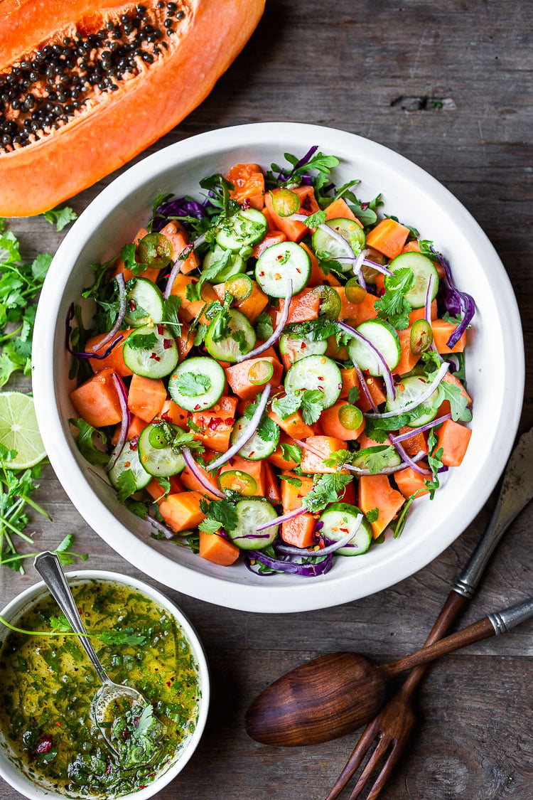 A simple Mexican Papaya Salad using ripe papaya with cucumber, red onions, jalapeño over greens with a Cilantro Lime Dressing. Easy and delicious, Vegan and Gluten-free. #papaya #papayasalad 