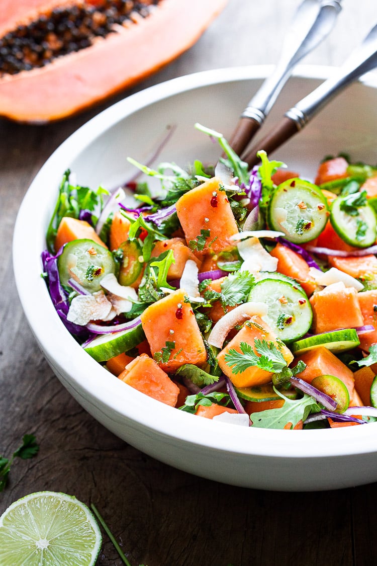 A simple Mexican-inspired Papaya Salad with cucumber, red onions, jalapeño over greens with a Cilantro Lime Dressing. #papayasalad 