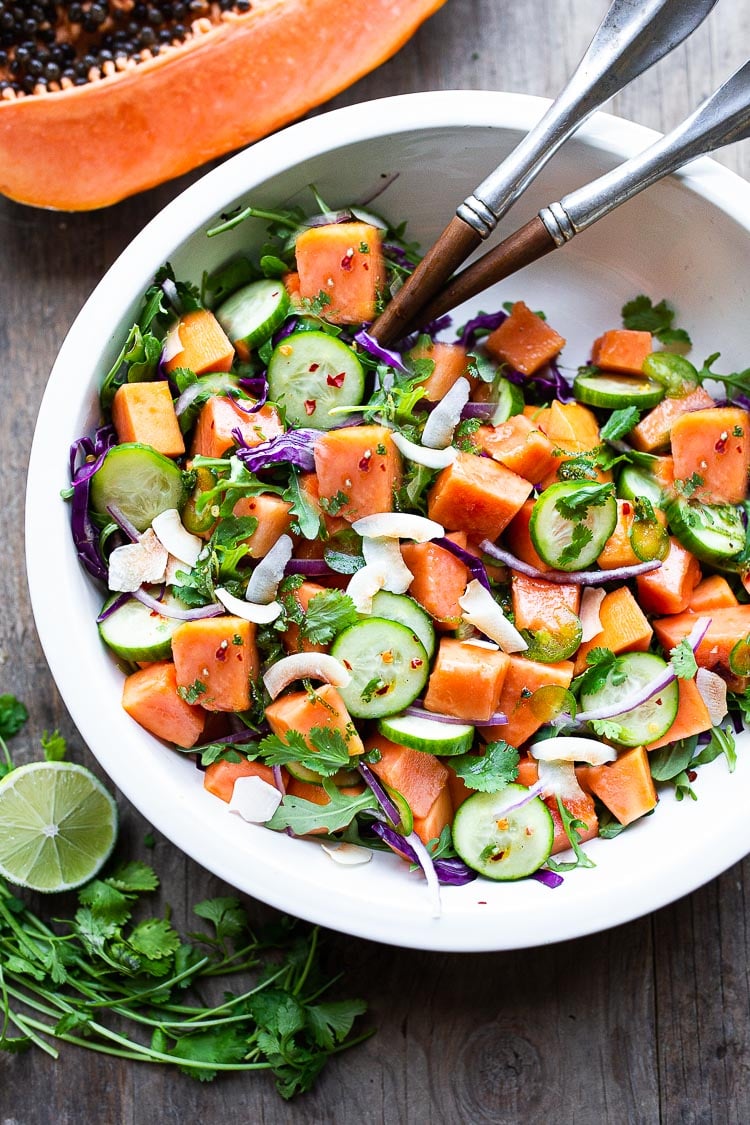 A simple Mexican Papaya Salad using ripe papaya with cucumber, red onions, jalapeño over greens with a Cilantro Lime Dressing. Easy and delicious, Vegan and Gluten-free. #papaya #papayasalad 