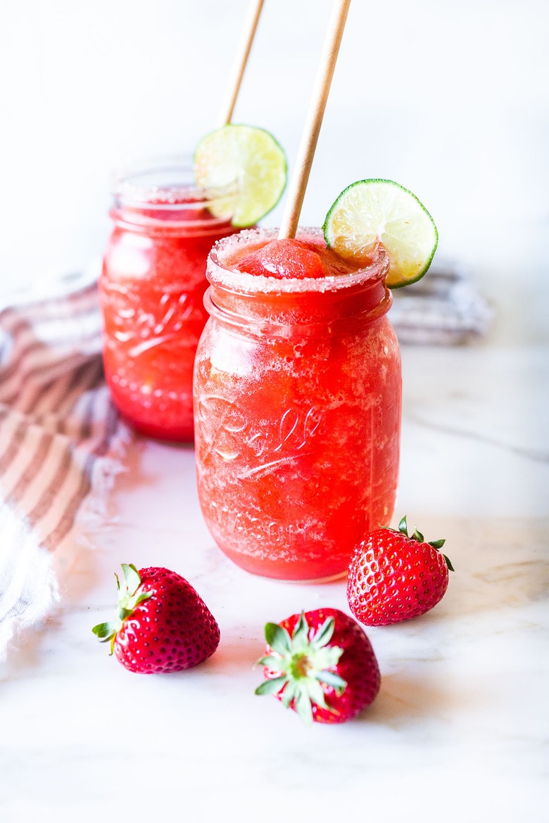 A easy recipe for fresh, blended Strawberry Margaritas using ripe, juicy, in season strawberries. These frozen Margaritas are naturally sweetened and have the best flavor! #margarita #strawberrymargarita 