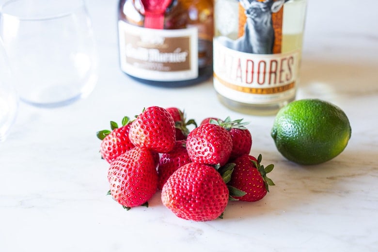 An easy recipe for fresh Strawberry Margaritas using ripe, juicy, in season strawberries! These blended Strawberry Margaritas are light and refreshing and go down a little too easy! Naturally sweetened, nicely balanced with the best flavor! 