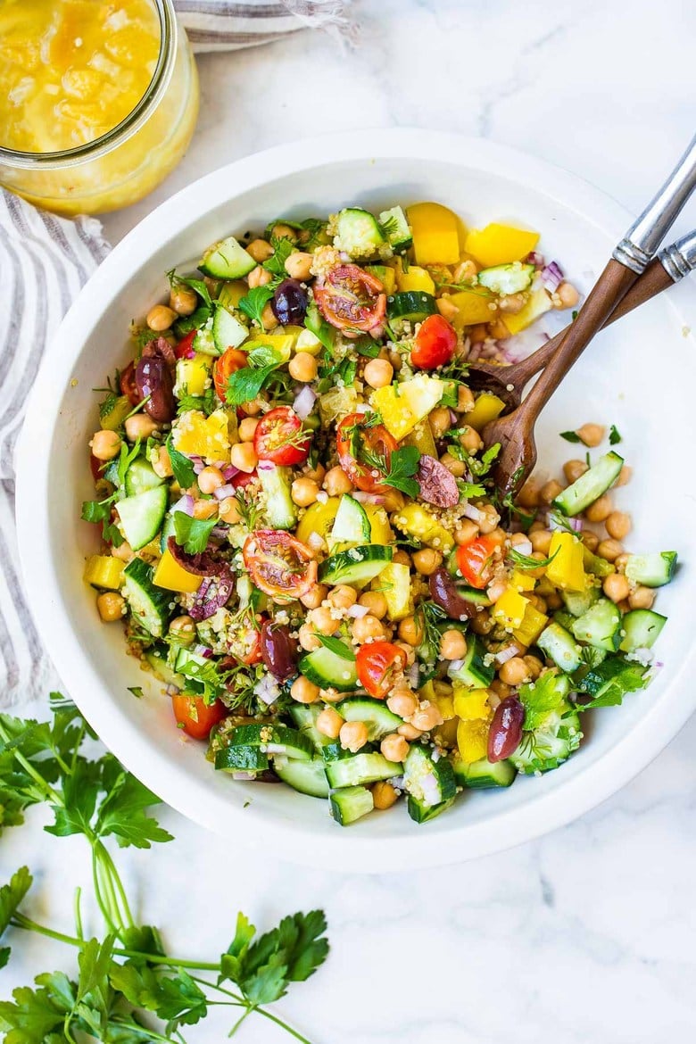 One of our most popular salads, this Lemony Chickpea Quinoa Salad with cucumber, tomato, dill, parsley and Preserved Lemon Dressing, makes a lovely potluck dish! #chickpeasalad #quinoasalad