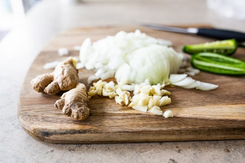 chopping onion, garlic, chilies and ginger